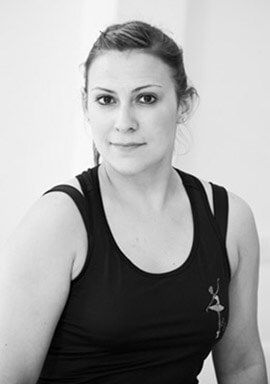 Woman in black tank top, looking at the camera. Black and white photo.
