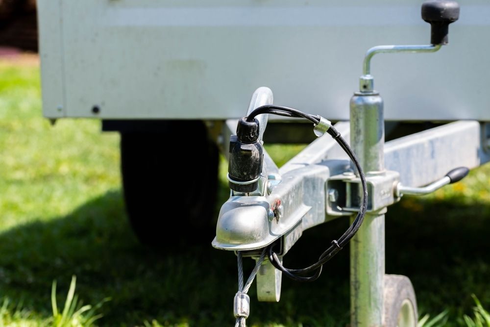 A Silver Trailer Hitch With a Connected Electrical Plug — Direct Current Solutions in Mareeba, QLD