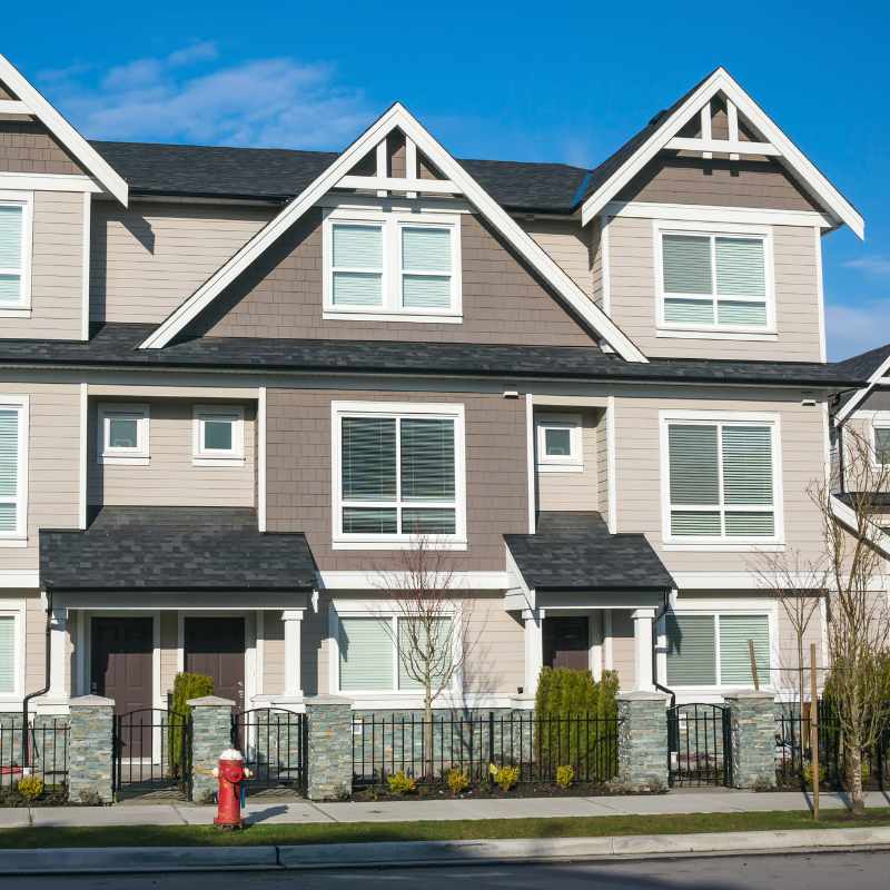 A row of houses with a fire hydrant in front of them