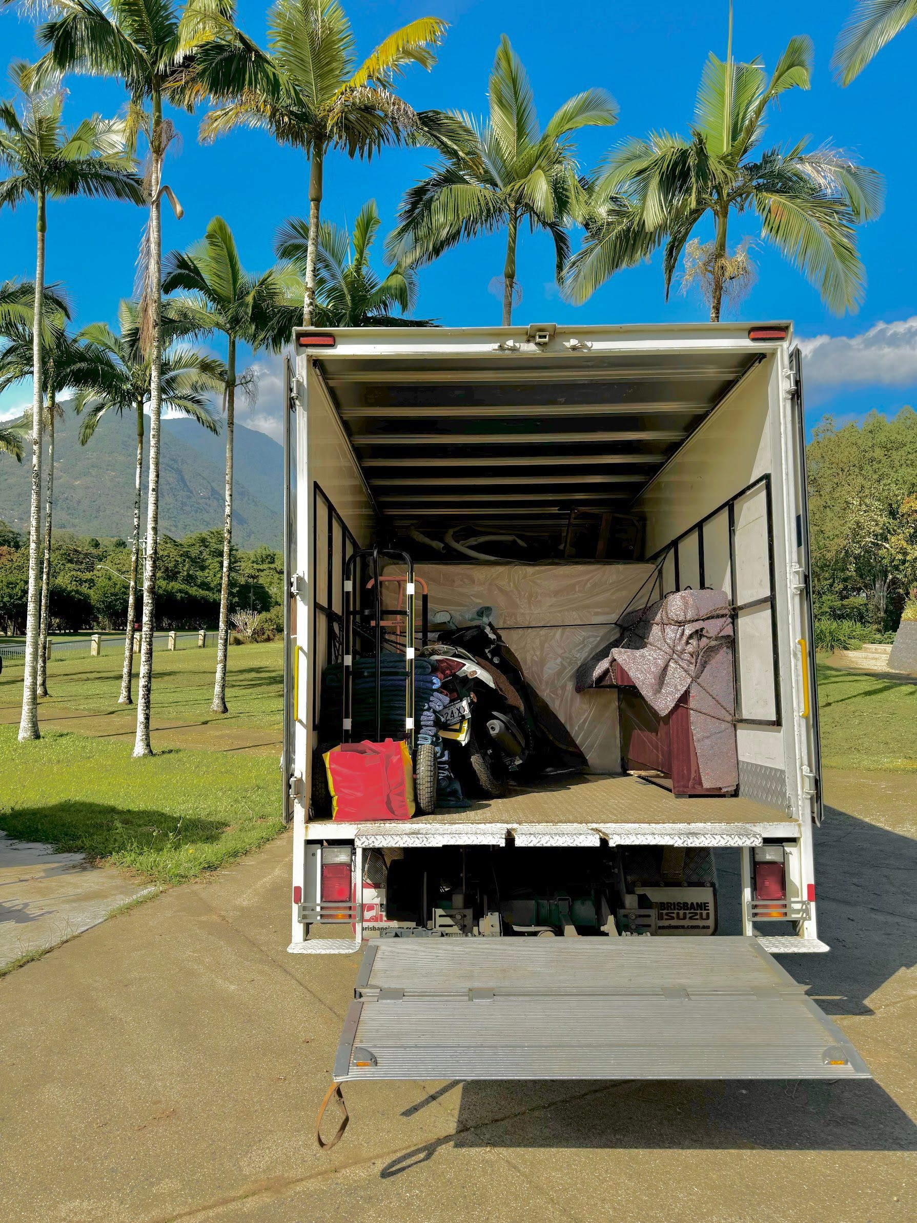White Delivery Truck Parked in Front of a Brick Building — Uplift Removals in Sunshine Coast, QLD