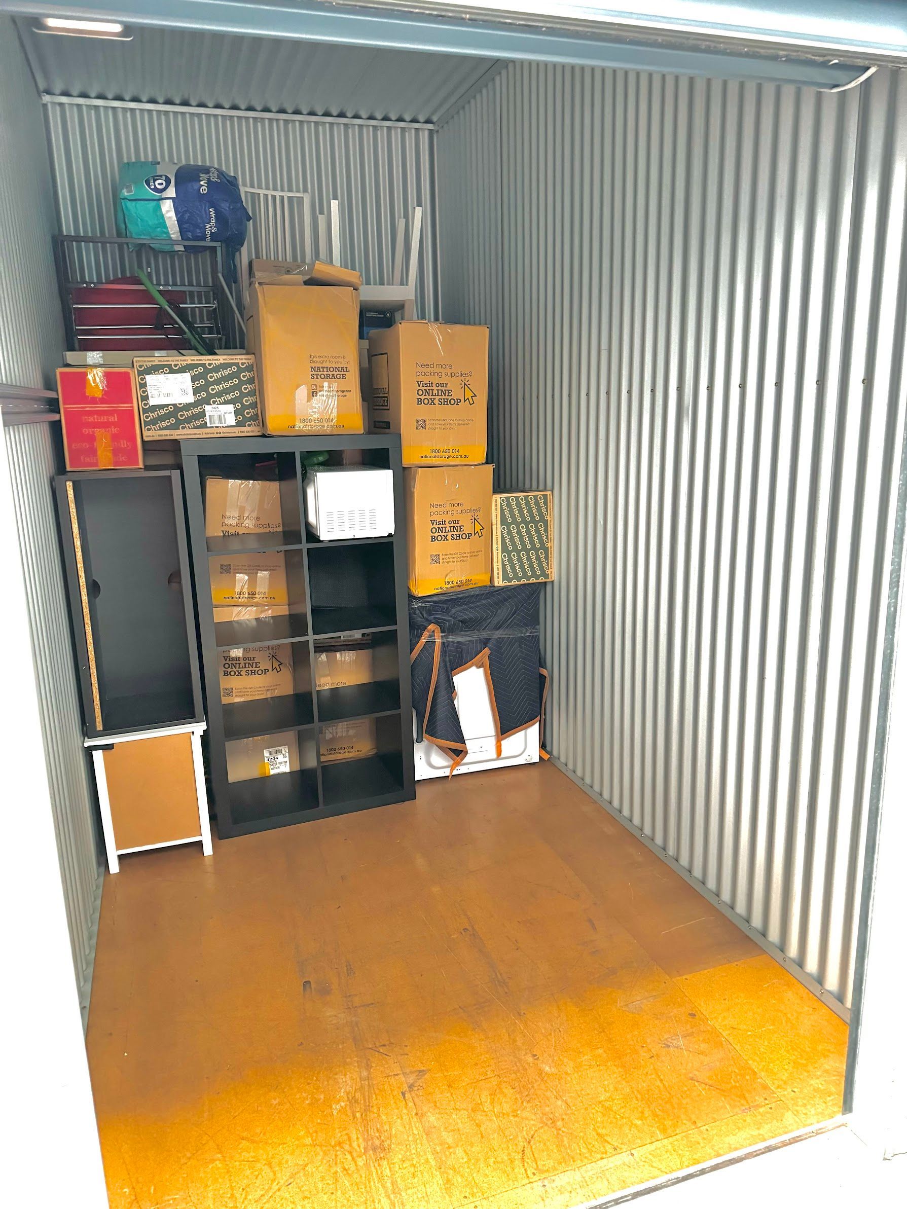 An Office With A Desk, Chair, Computer And Boxes On The Floor — Uplift Removals in Burdell, QLD