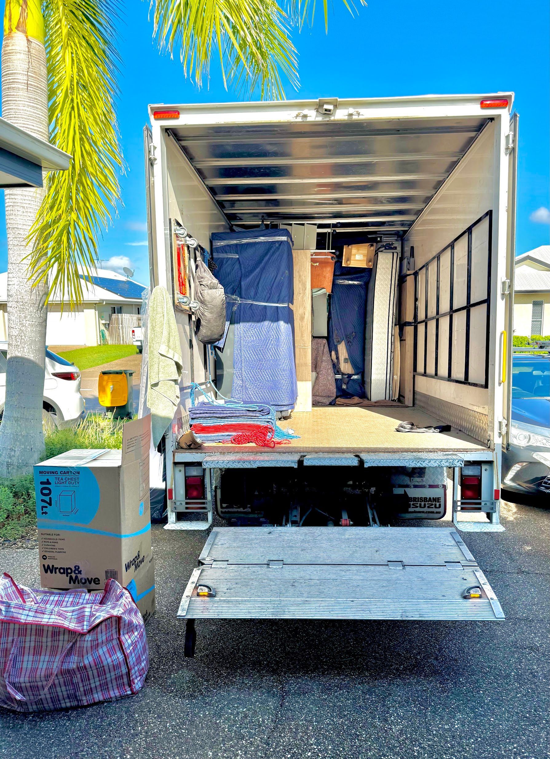 A Living Room Filled With Cardboard Boxes And A Couch — Uplift Removals in Sunshine Coast, QLD
