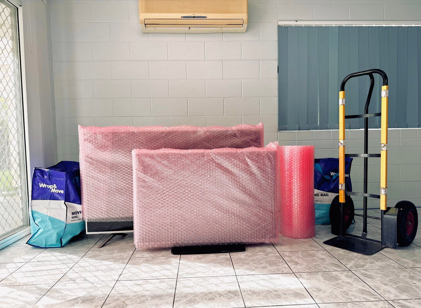 A Room Filled With Boxes, Chairs And A Lamp — Uplift Removals in Burdell, QLD