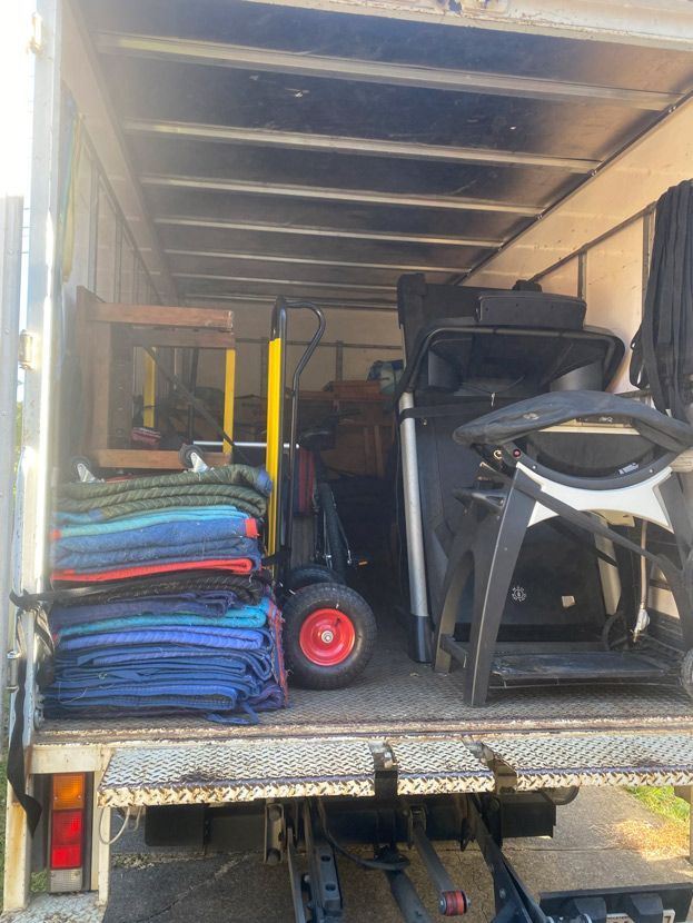 The Back Of A Moving Truck Filled With Furniture And A Treadmill — Uplift Removals in Burdell, QLD
