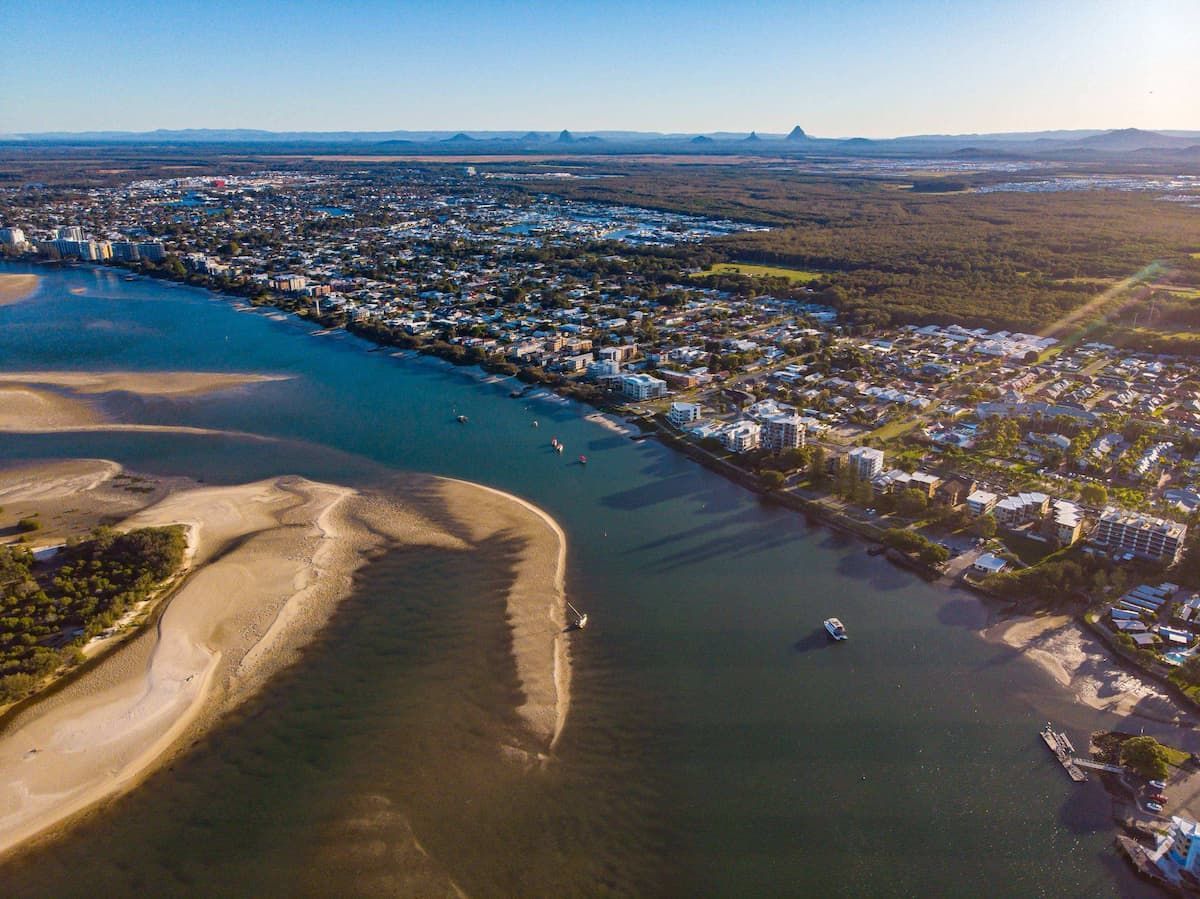 Aerial View of A Coastal Town with A River Inlet, Sandbars — Uplift Removals in South Townsville, QLD