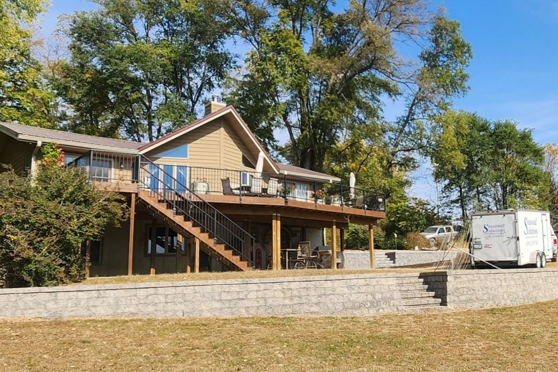 An aerial view of a house with a gray roof