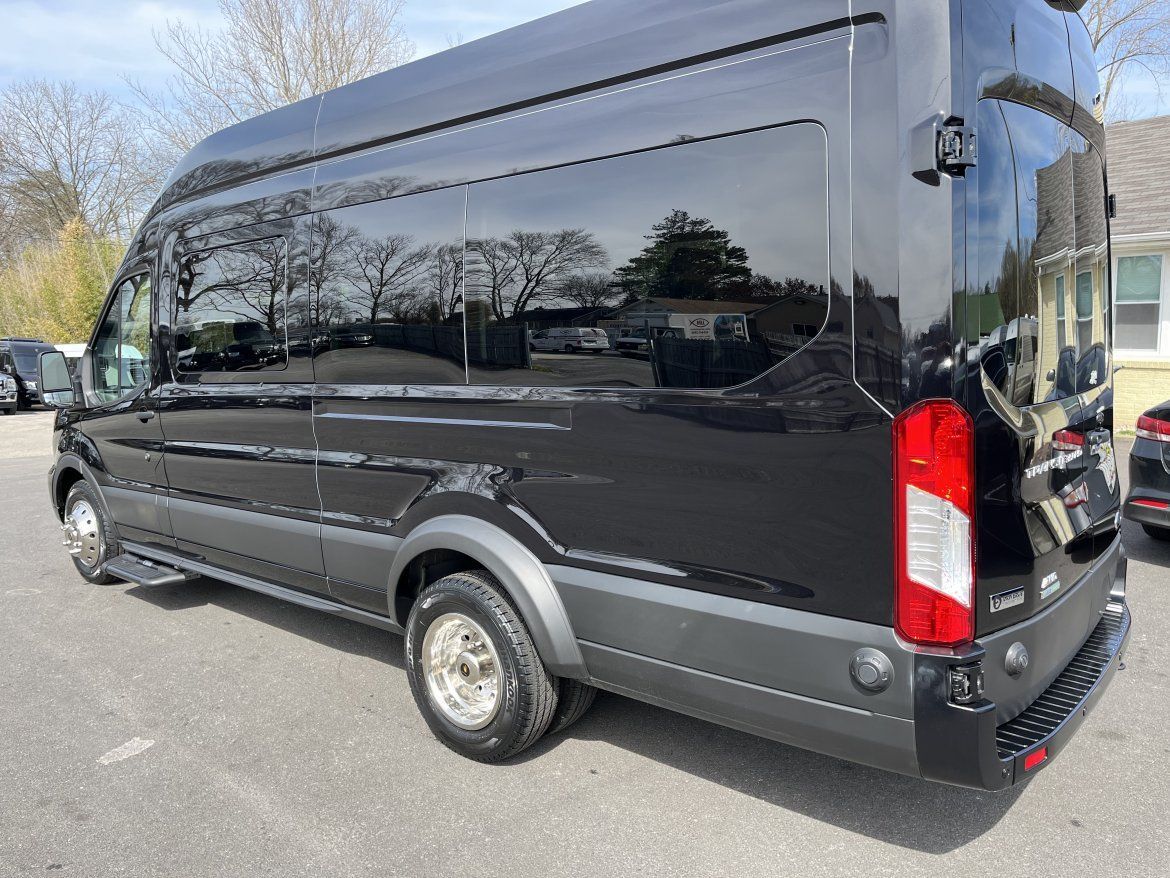 Black passenger van parked outdoors with tinted windows.
