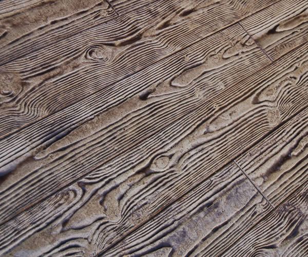 Weathered wooden plank surface with visible grain and knots, shown in a diagonal close-up.