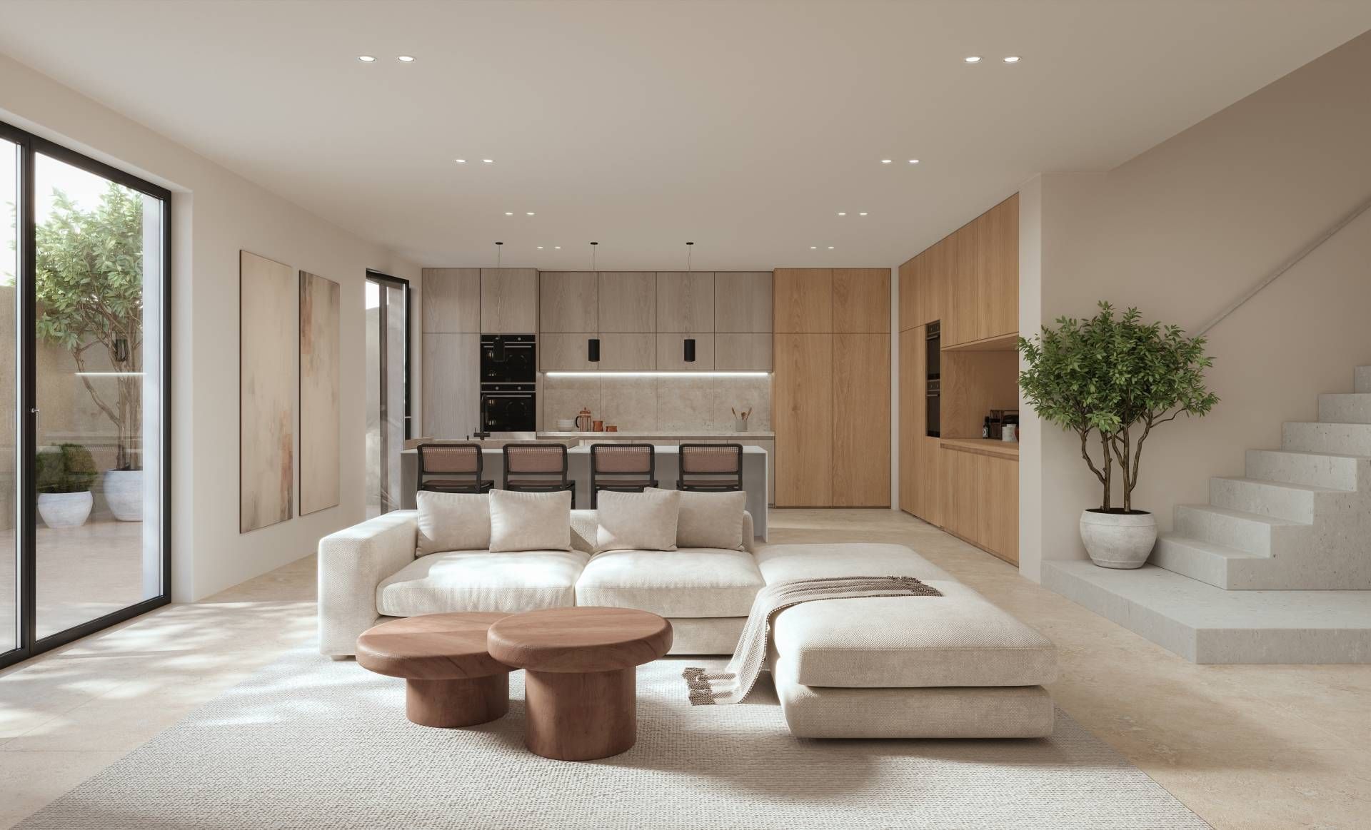 Bright minimalist living room with beige sectional, wooden coffee tables, kitchen island, and stairs