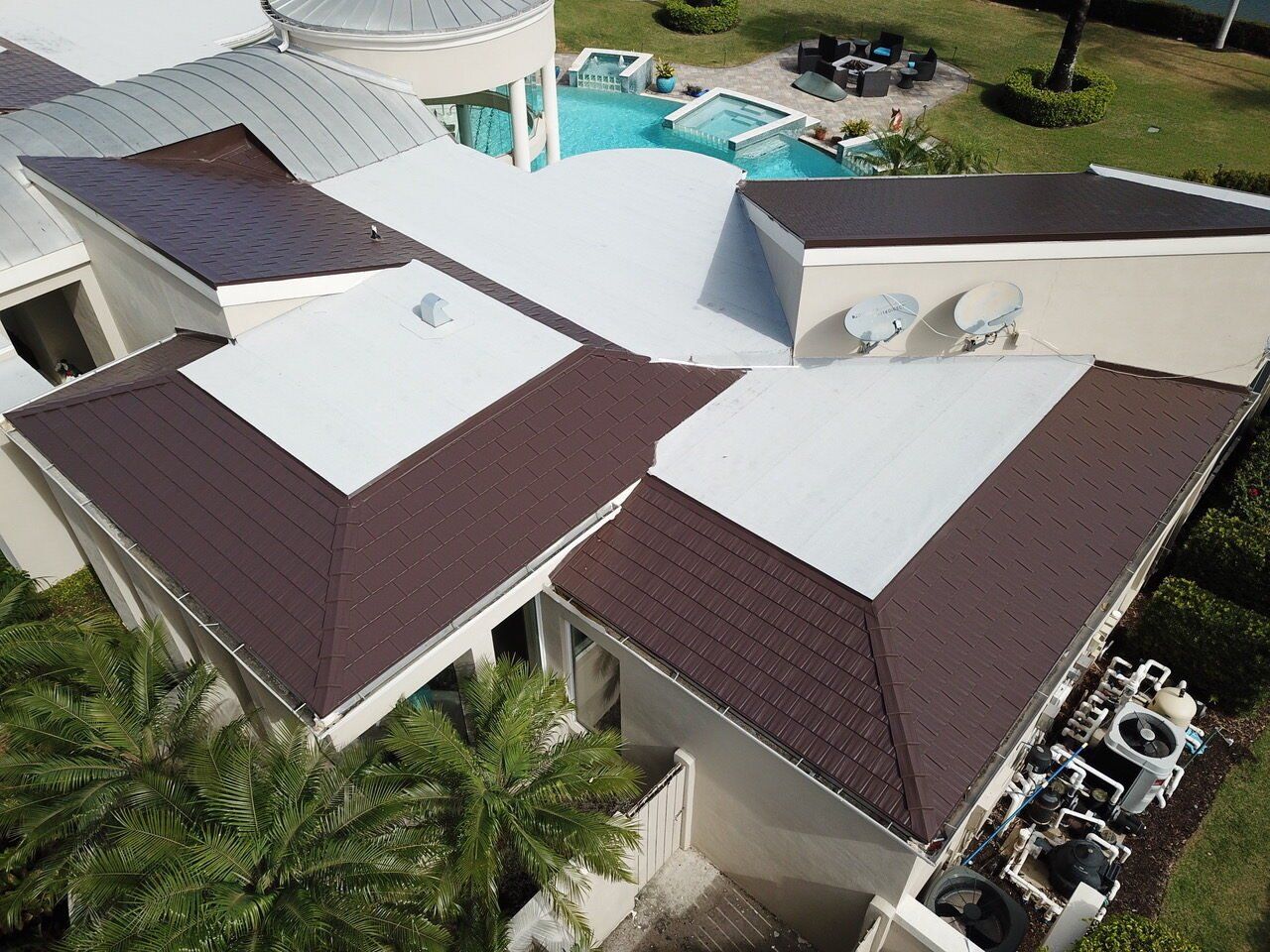Naples FL Colonial Brown Interlock Cedar Shingle install on a beautiful rancher home with pool. Flat white membrane roof also shown.