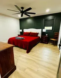 An interior view showing a transition between two different wood floors, with a freshly finished room in the background.