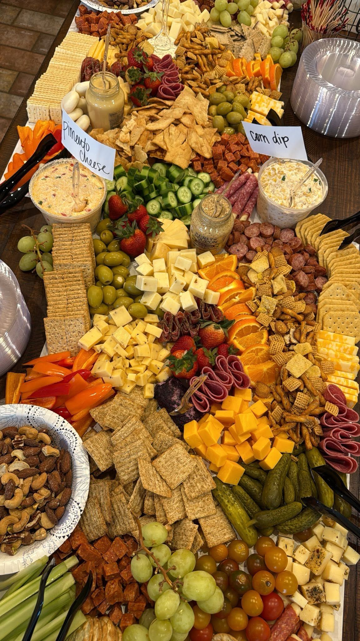 grazing board with meat, cheese, fruit, and dips
