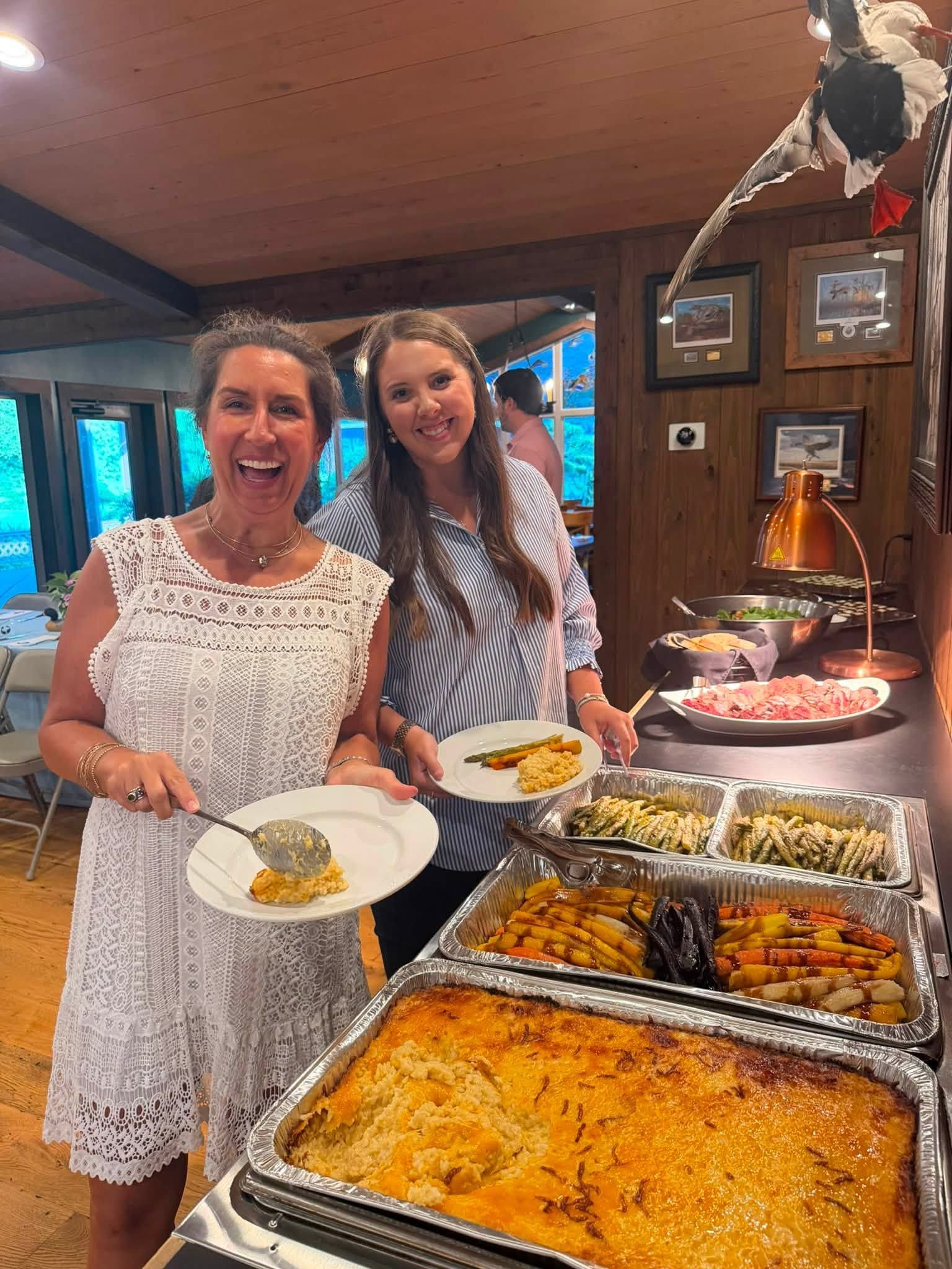 party guests serving plates from buffet style catering