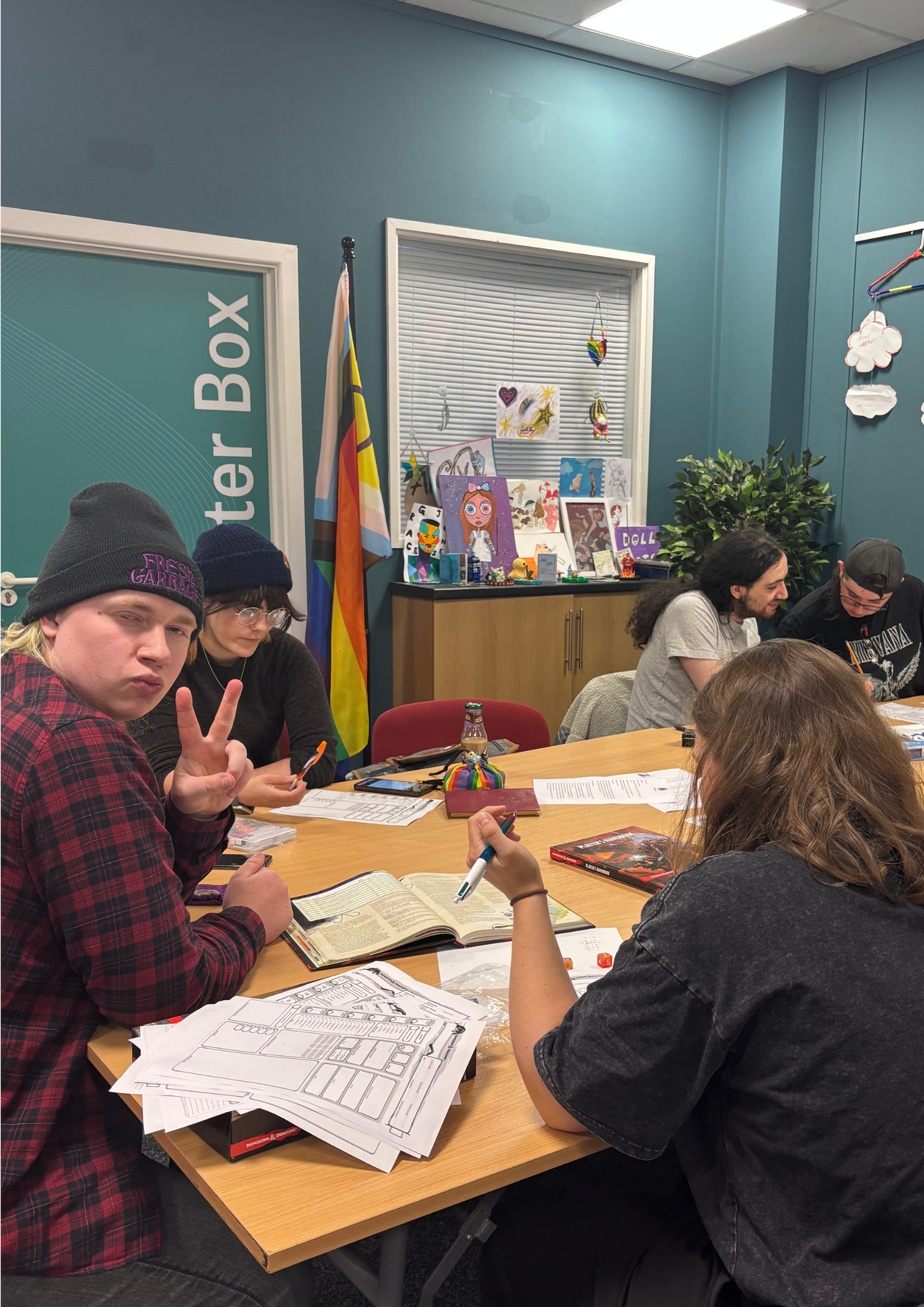 People sat around a table playing Dungeons and Dragons