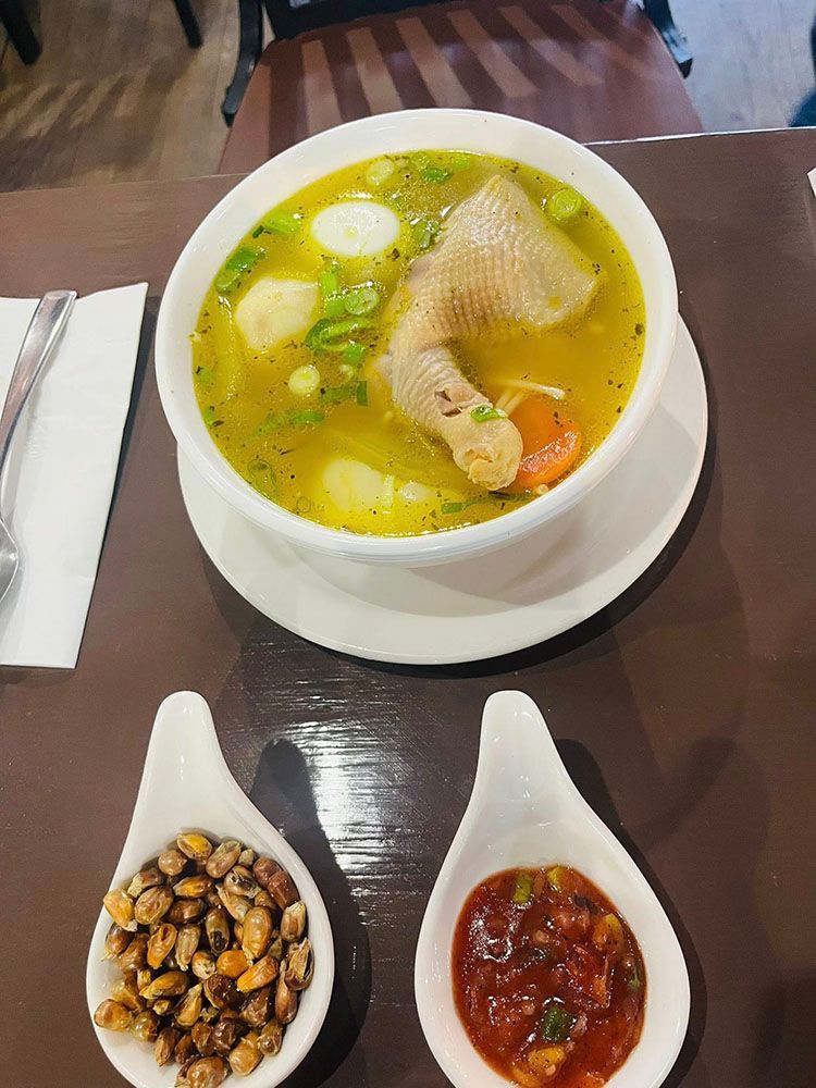 Chicken soup in a white bowl