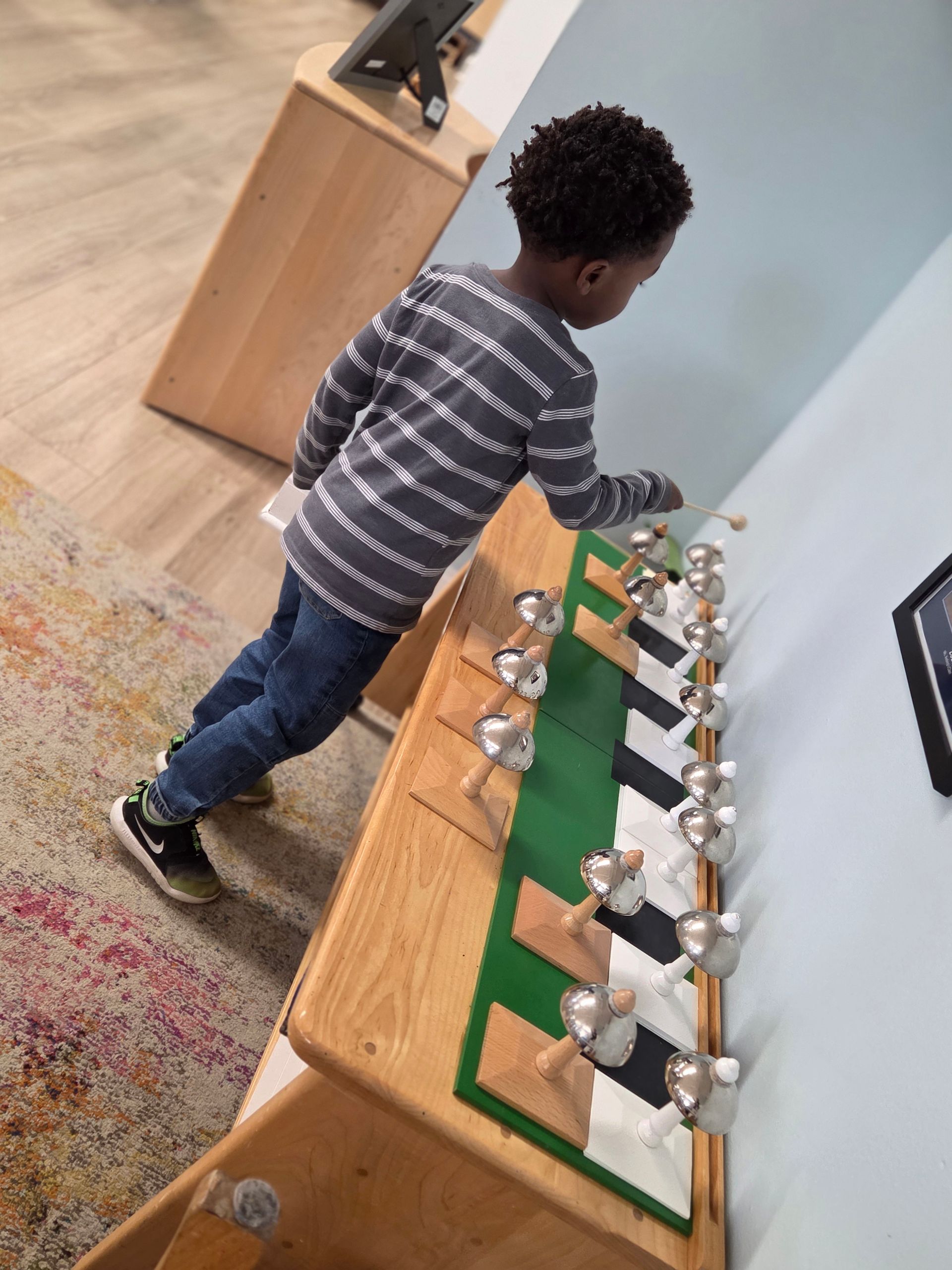 Child working with the Montessori bells in a classroom