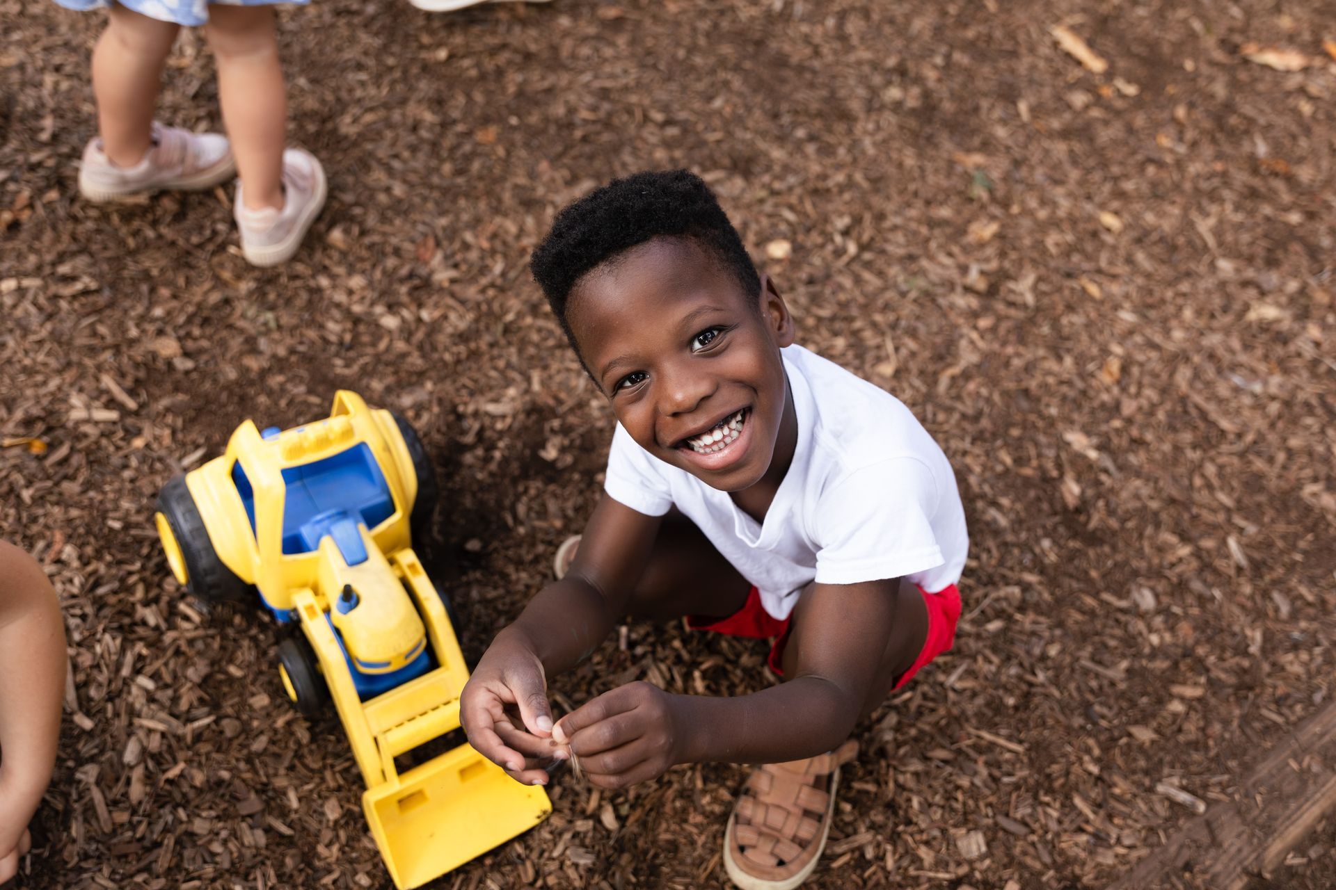 Montessori child playing outside the classroom