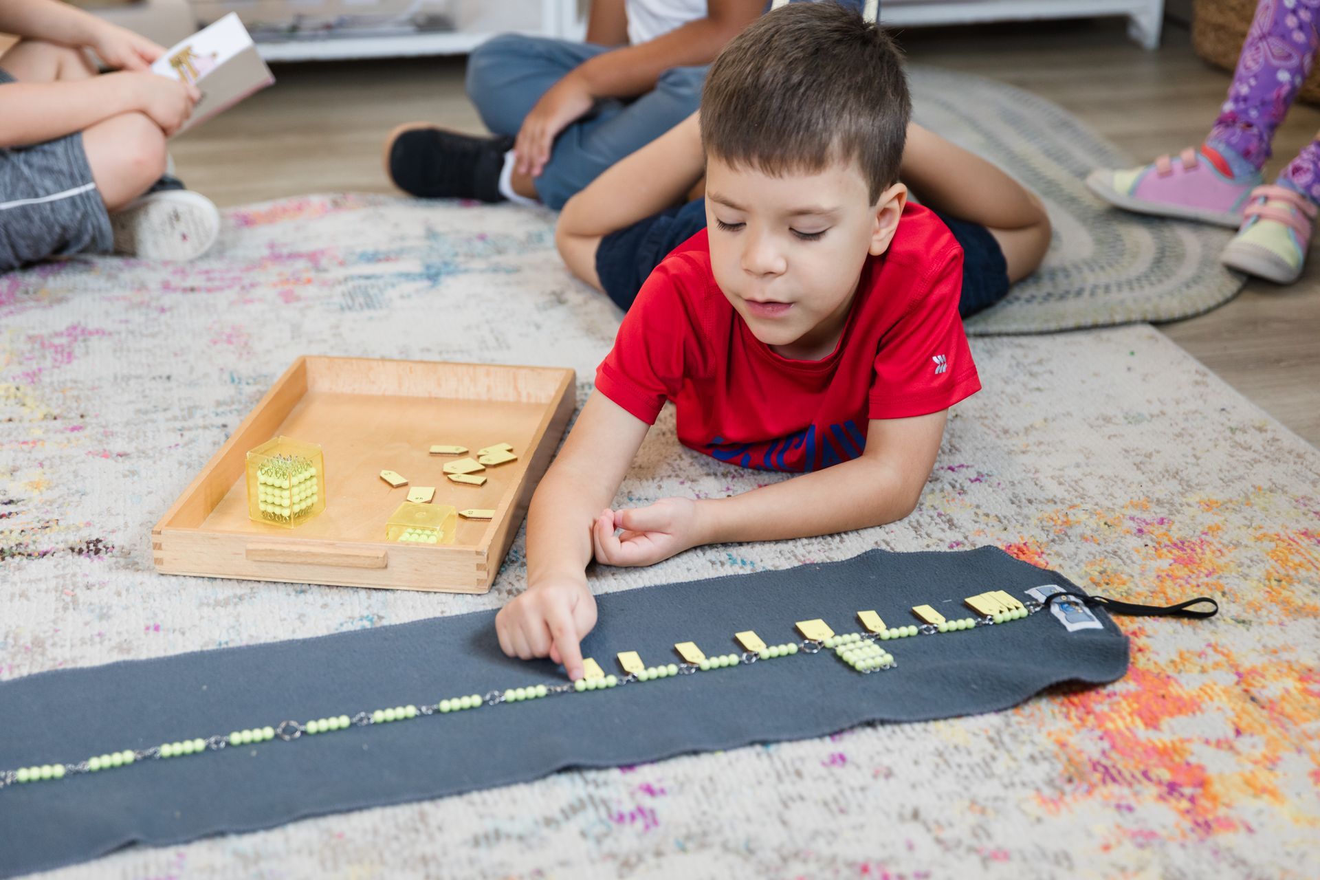 Montessori child working with math beads