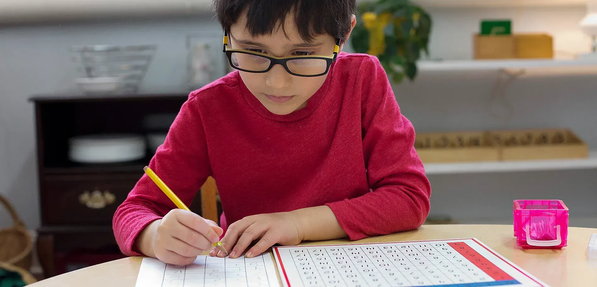 Montessori child working with written activity