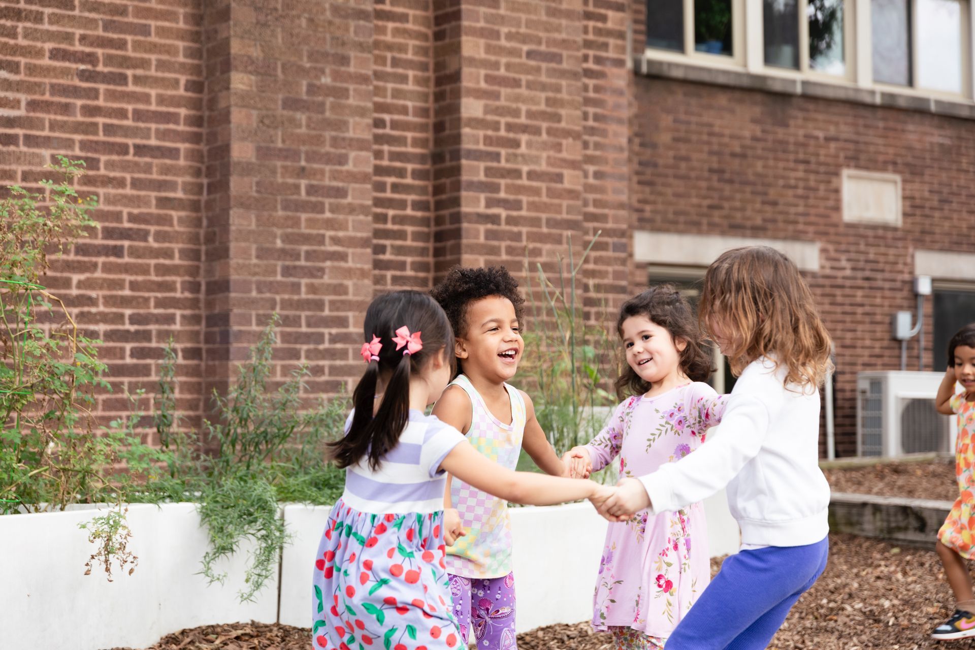 Montessori children happy playing outside the classroom