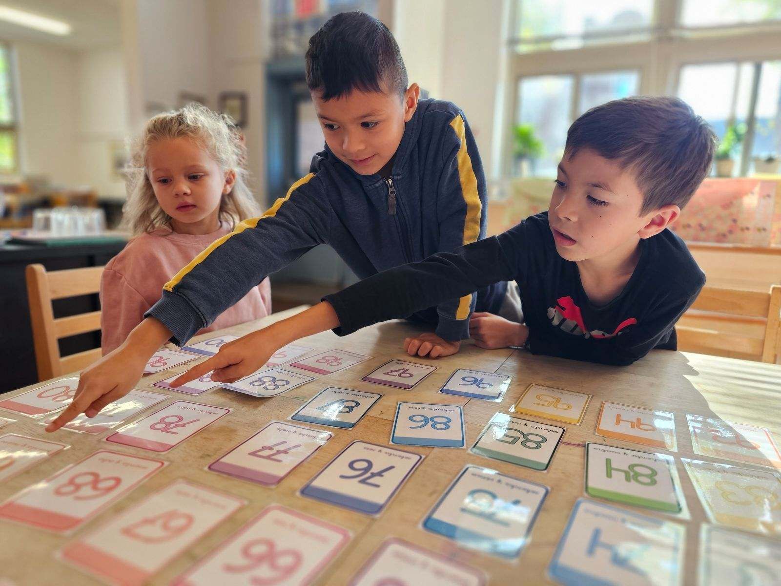 montessori children working with spanish activity