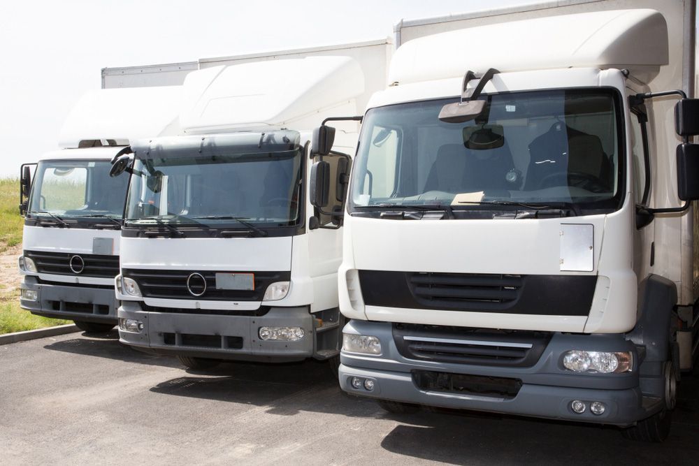 Three Trucks Are Parked Next to Each Other in A Parking Lot — Alice Hosetech & Industrial Supplies in Ciccone, NT