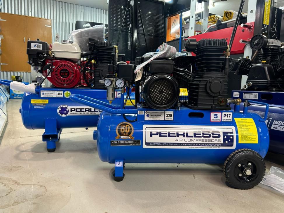 Two Blue Air Compressors Are Sitting Next to Each Other in A Warehouse — Alice Hosetech & Industrial Supplies in Ciccone, NT
