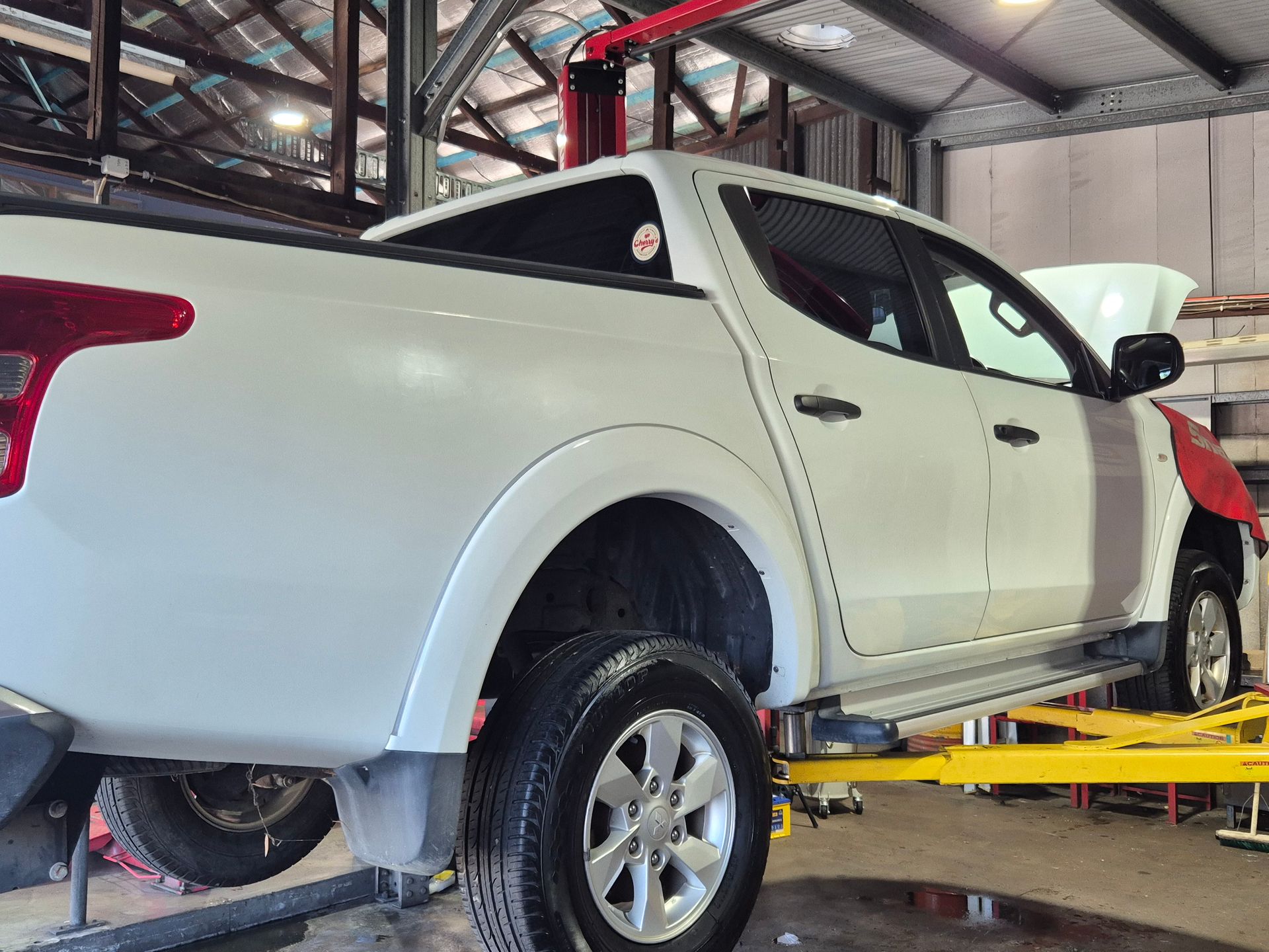 A Diesel Car on the Hoist At Cherry's Automotive Repairs in Maitland