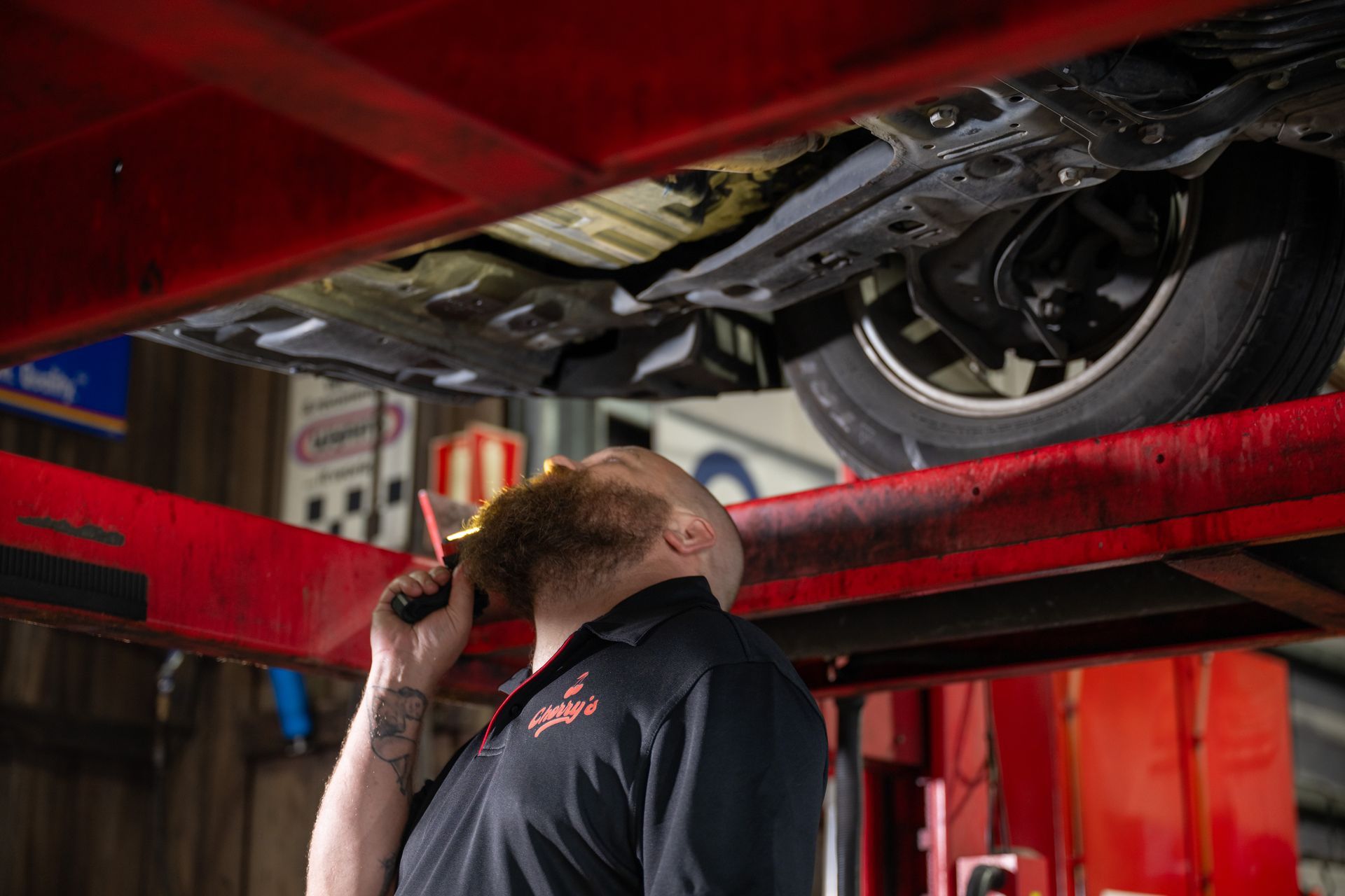 A Mechanic At Cherry's Automotive Servicing A Car