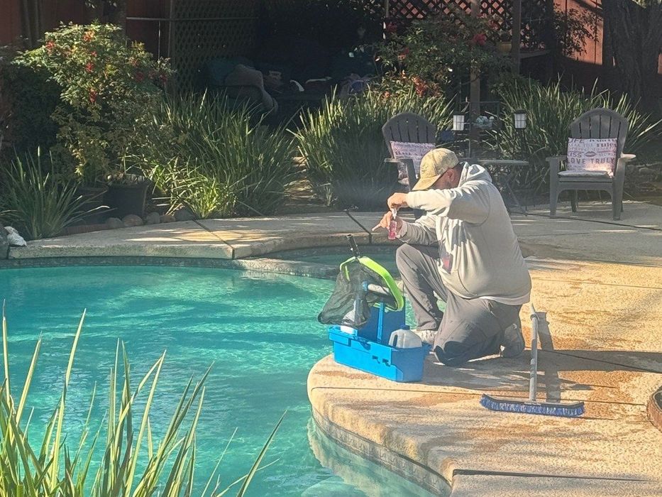 Manny, Sunfish Pool Service lead tech, testing the water at a Sacramento pool