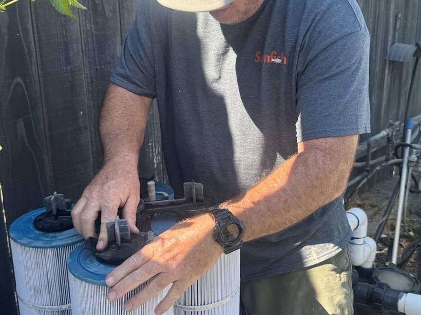 Sunfish Pool Service technician cleaning a pool filter cartridge in Sacramento
