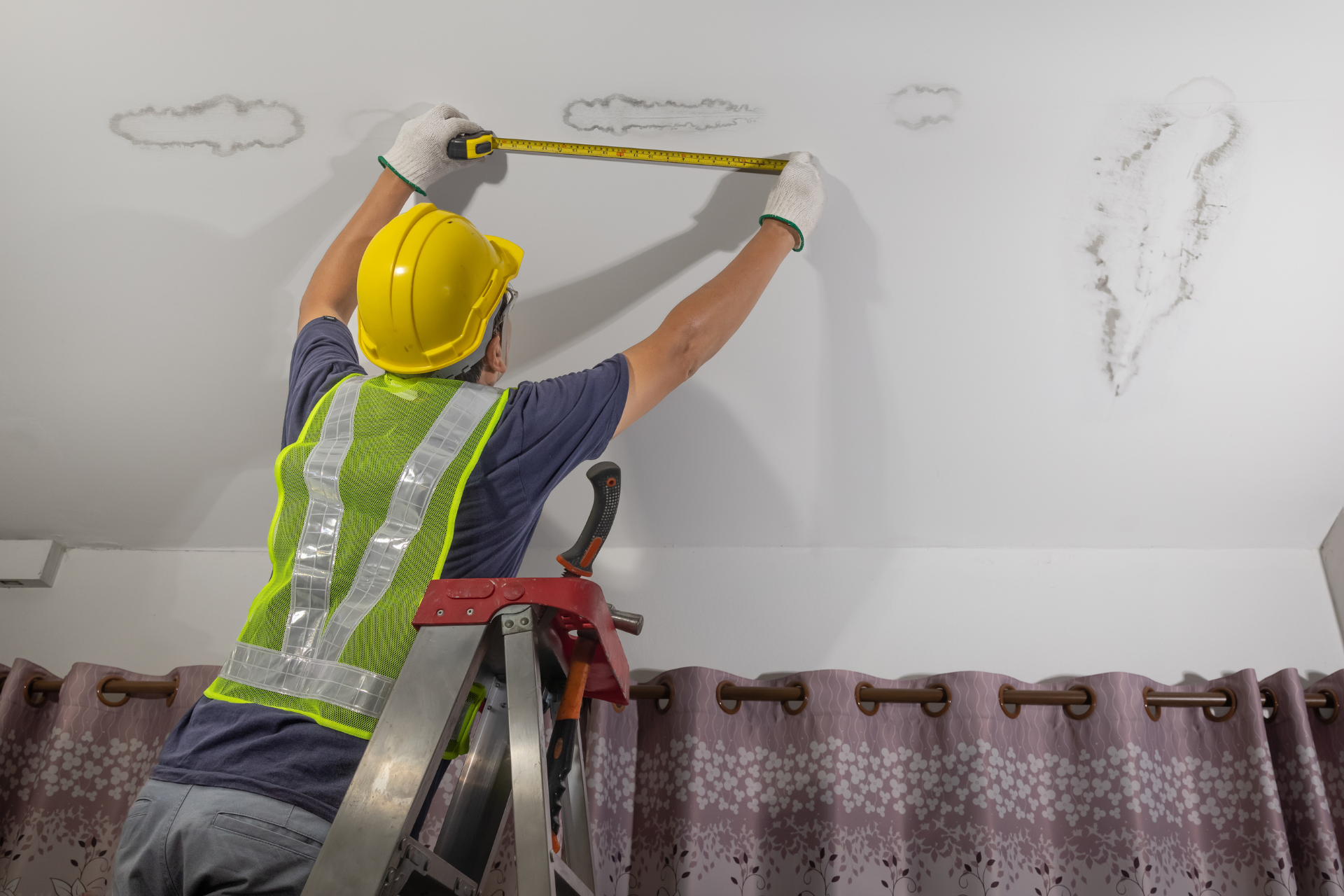 Worker Fixing Leaking Pipe on Ceiling