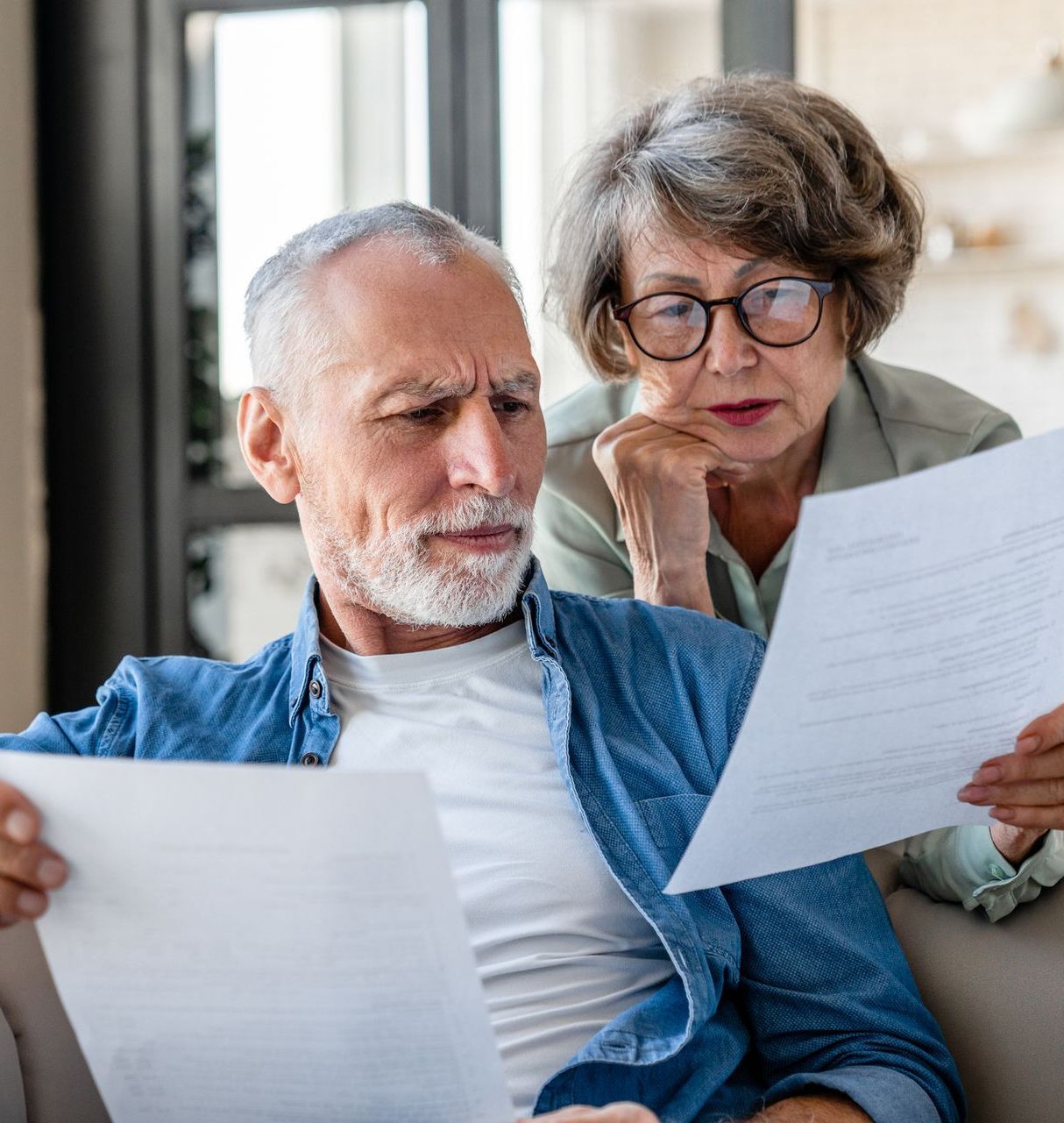Image of an elderly couple looking over a legal document.