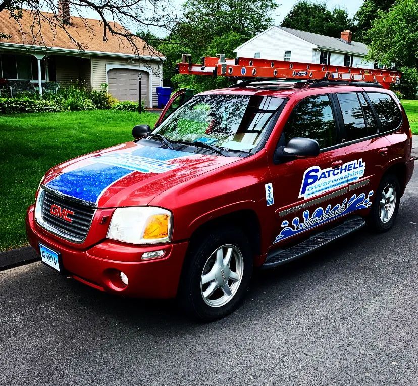 A red gmc suv is parked in front of a house