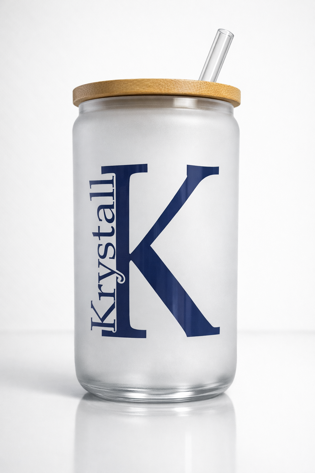 Frosted tumbler with bamboo lid and straw, featuring a large navy “K” and “Krystall