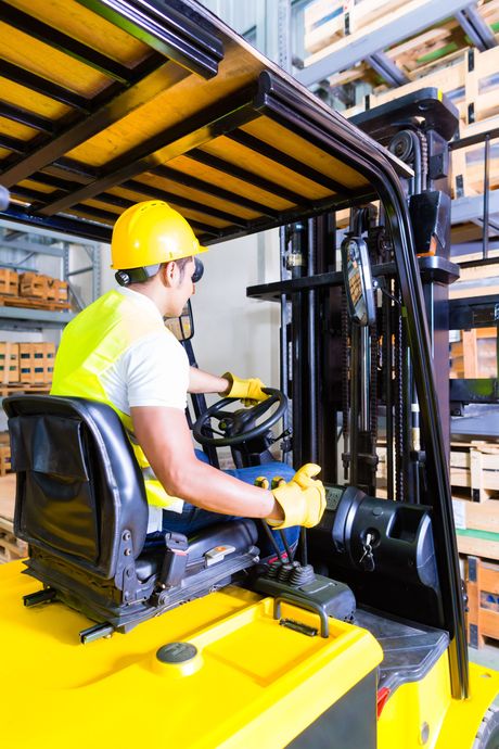 Worker using fork lift truck