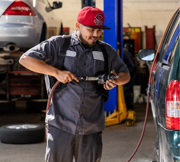 Expert technician in the garage prepared to do auto repair on customer's vehicle in San Bruno, CA | Hanlon's Tire Service