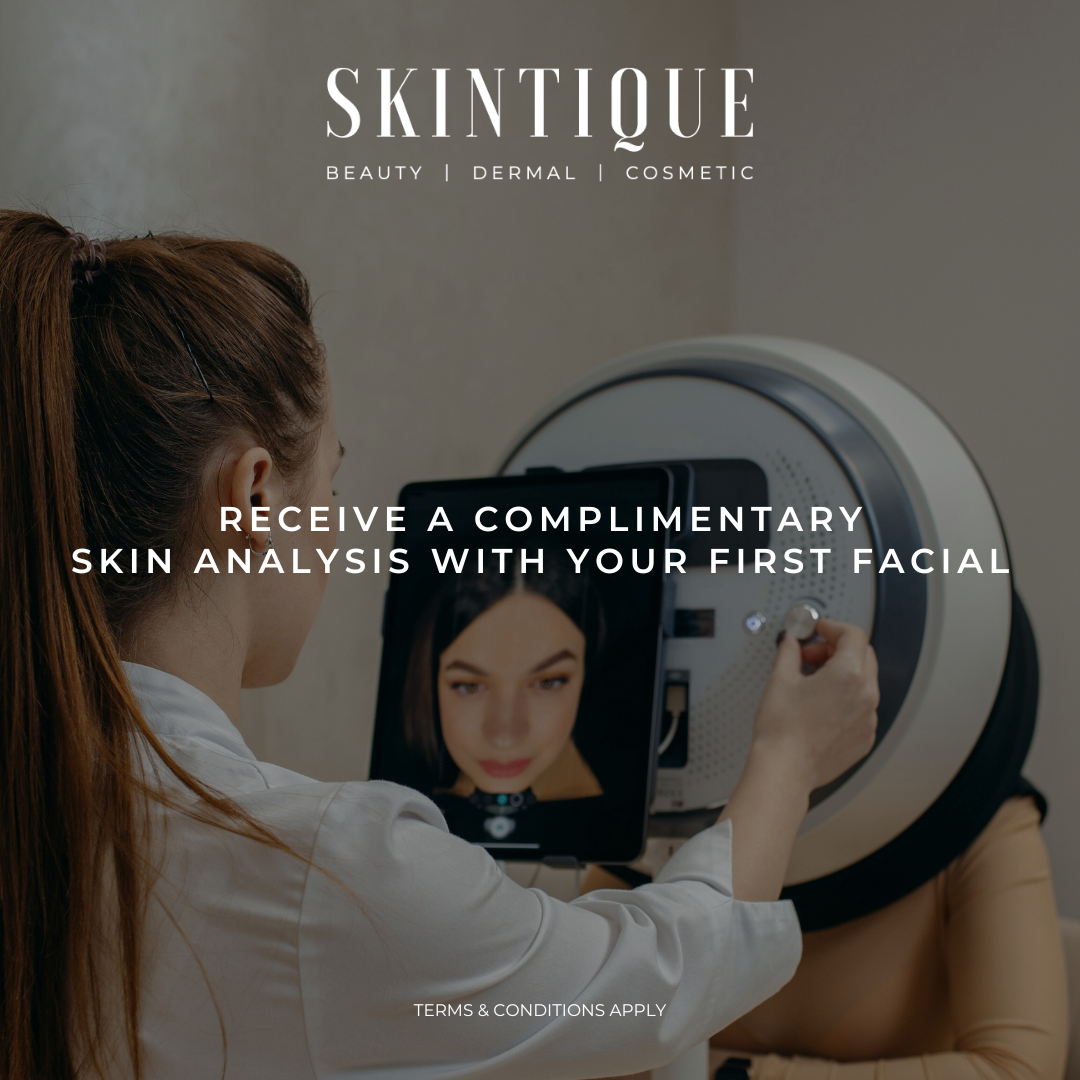Woman receiving a complimentary skin analysis during a facial at a skincare clinic