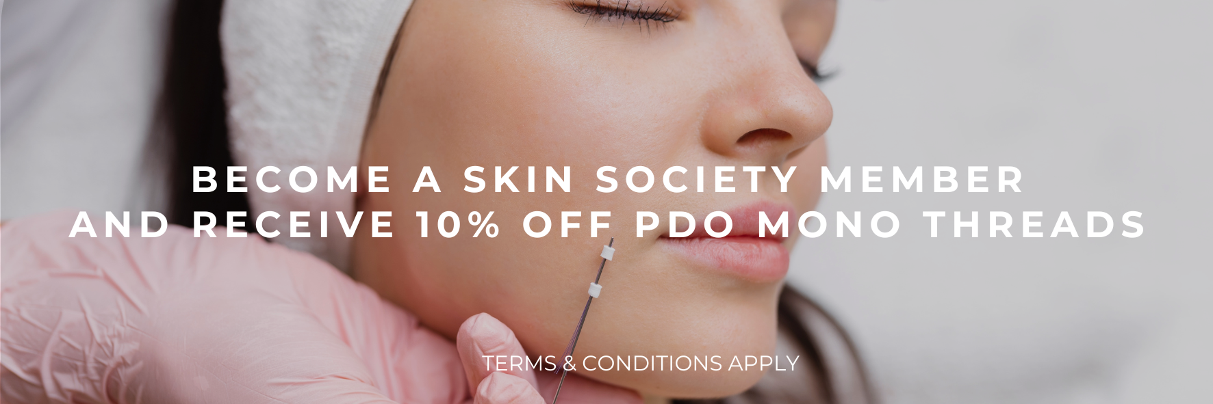 Woman receiving a facial massage with overlay text promoting 10% off PDO mono threads for skin society members