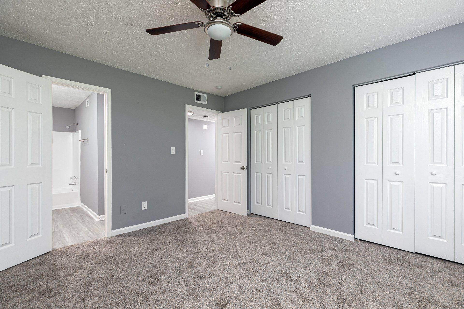 Apartments Near Hartsfield-Jackson International Airport - Briar Hill 563 - Spacious Bedroom With Plush Carpeting, Attached Bathroom, Ceiling Fan, And Two Closets.