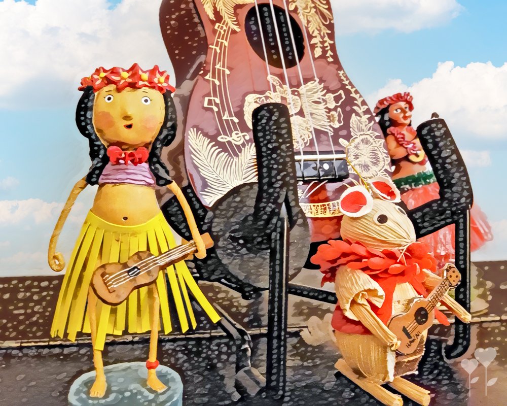 a statue of a hula girl playing an ukulele
