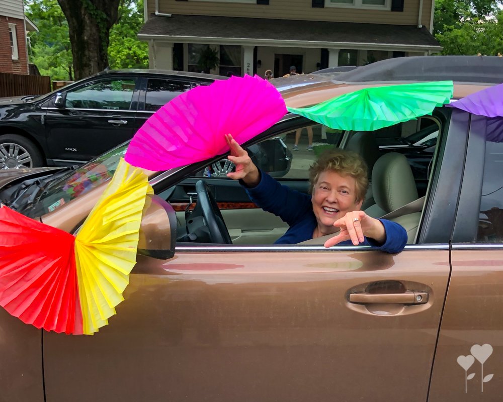 a woman in a car with paper fans on the side