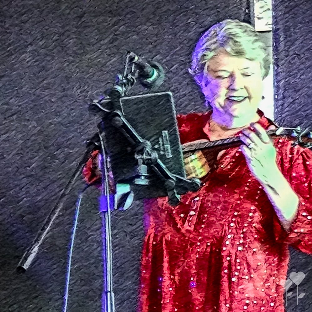 a woman in a red dress is playing a ukulele