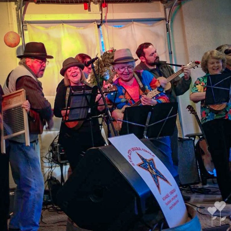 a group of people are playing instruments in front of a sign that says eagle creek