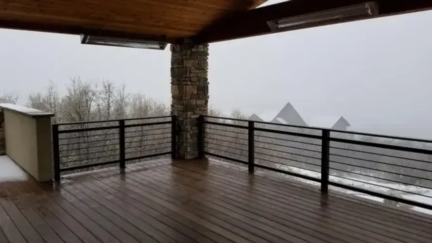 A modern black custom fabricated horizontal metal railing built and installed on a custom deck by 83MetalCraft, LLC in Boise, Idaho