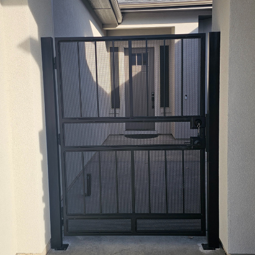 a black custom metal entrance gate fabricated and installed by 83MetalCraft, LLC