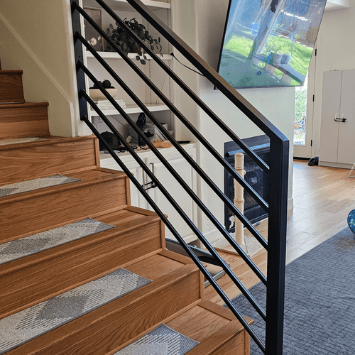 A black horizontal railing fabricated and installed by 83MetalCraft, LLC