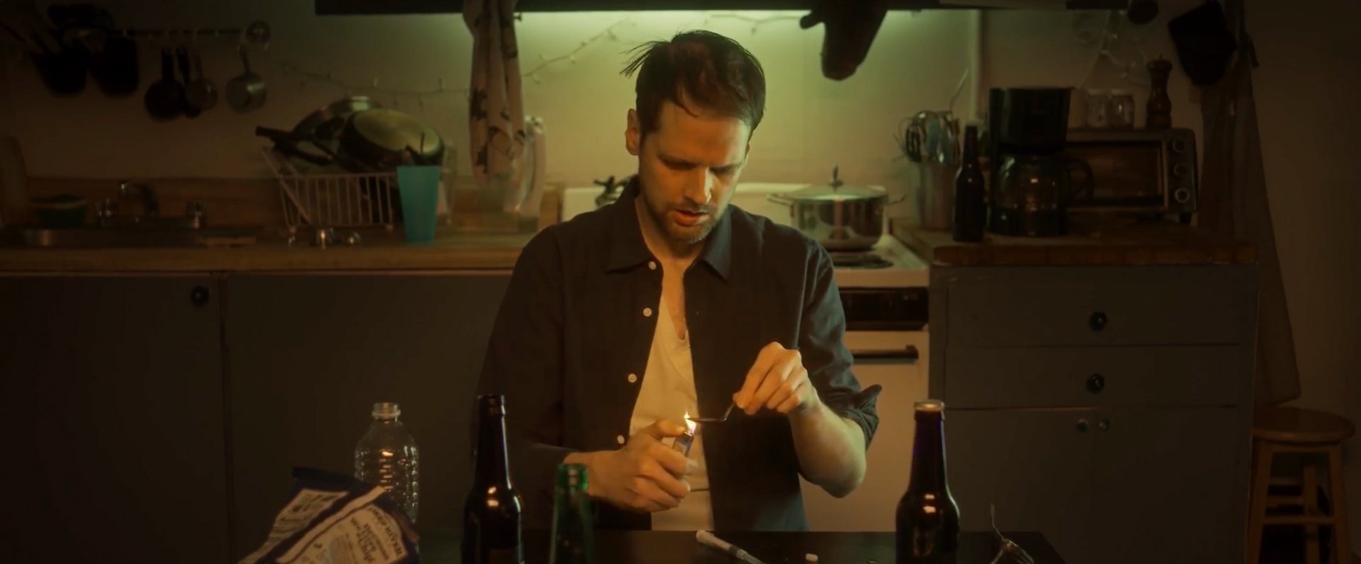 Man heating heroin in a spoon with a match 
