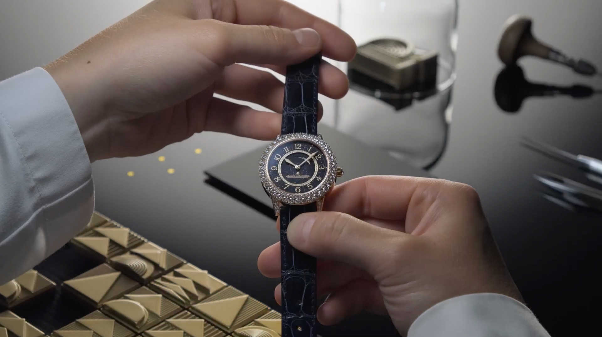 Two hands holding a watch