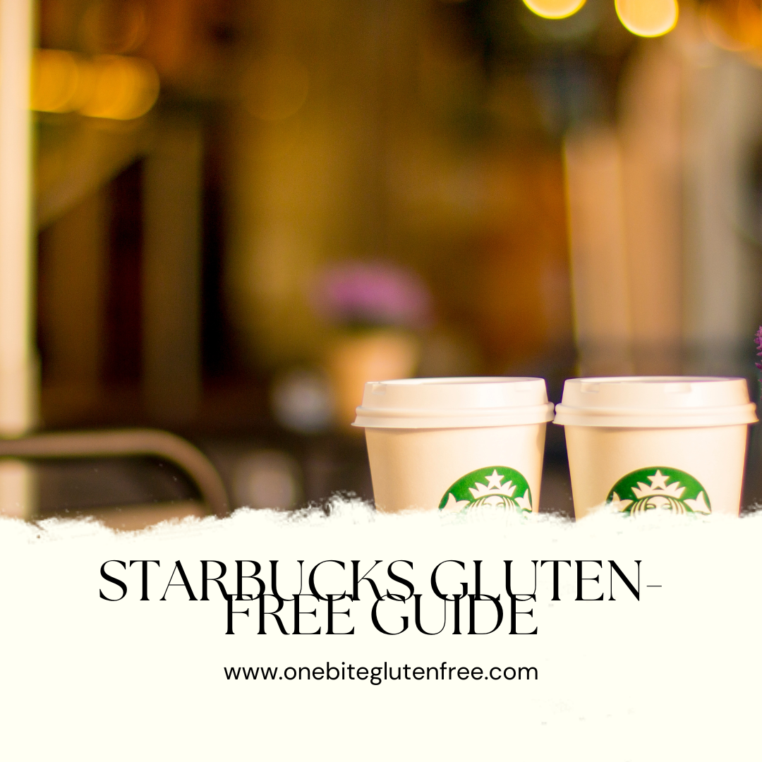 A cup of coffee with a green straw on the beach.